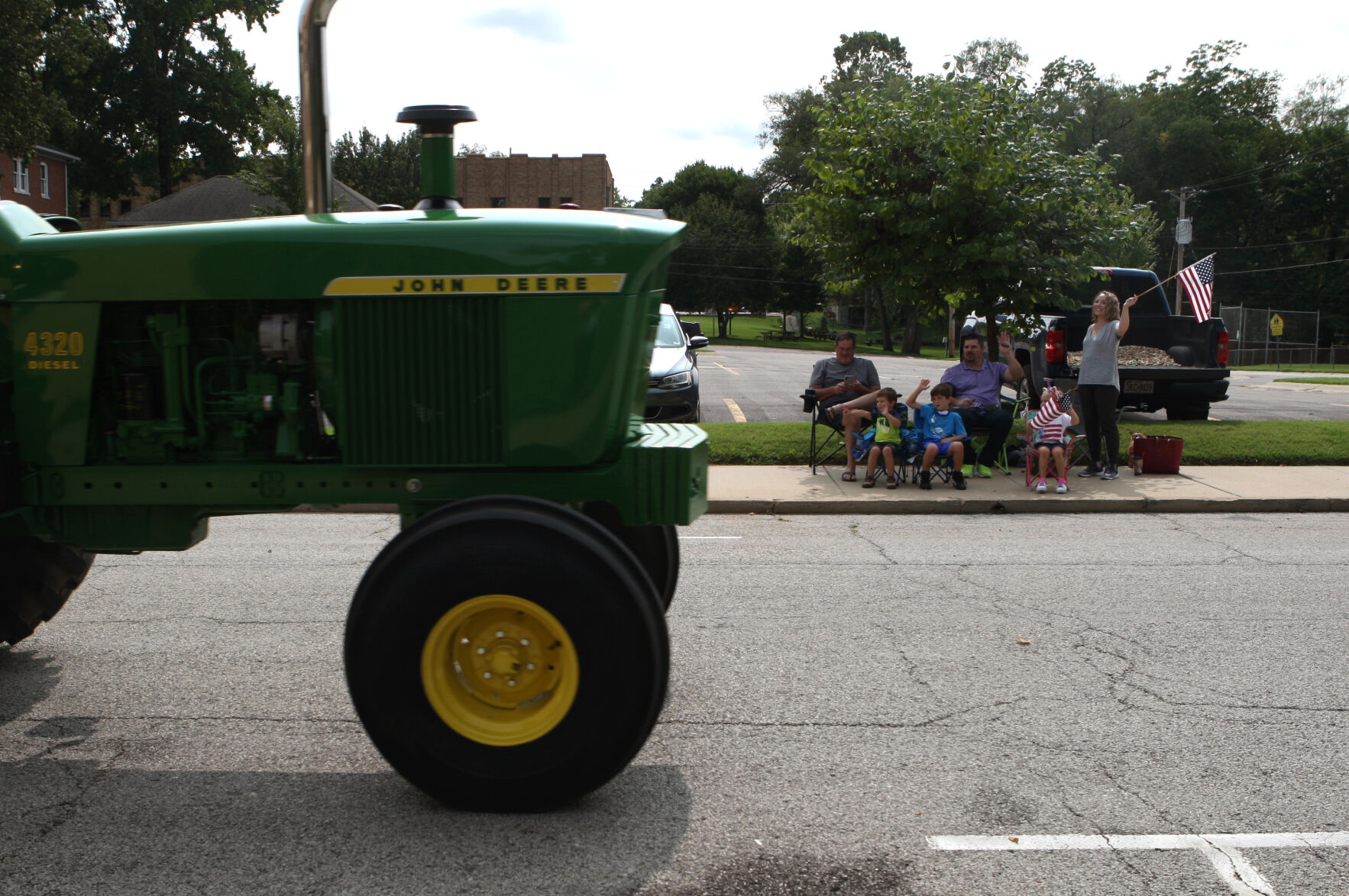 A John Deere Tractor rolls down Main Street